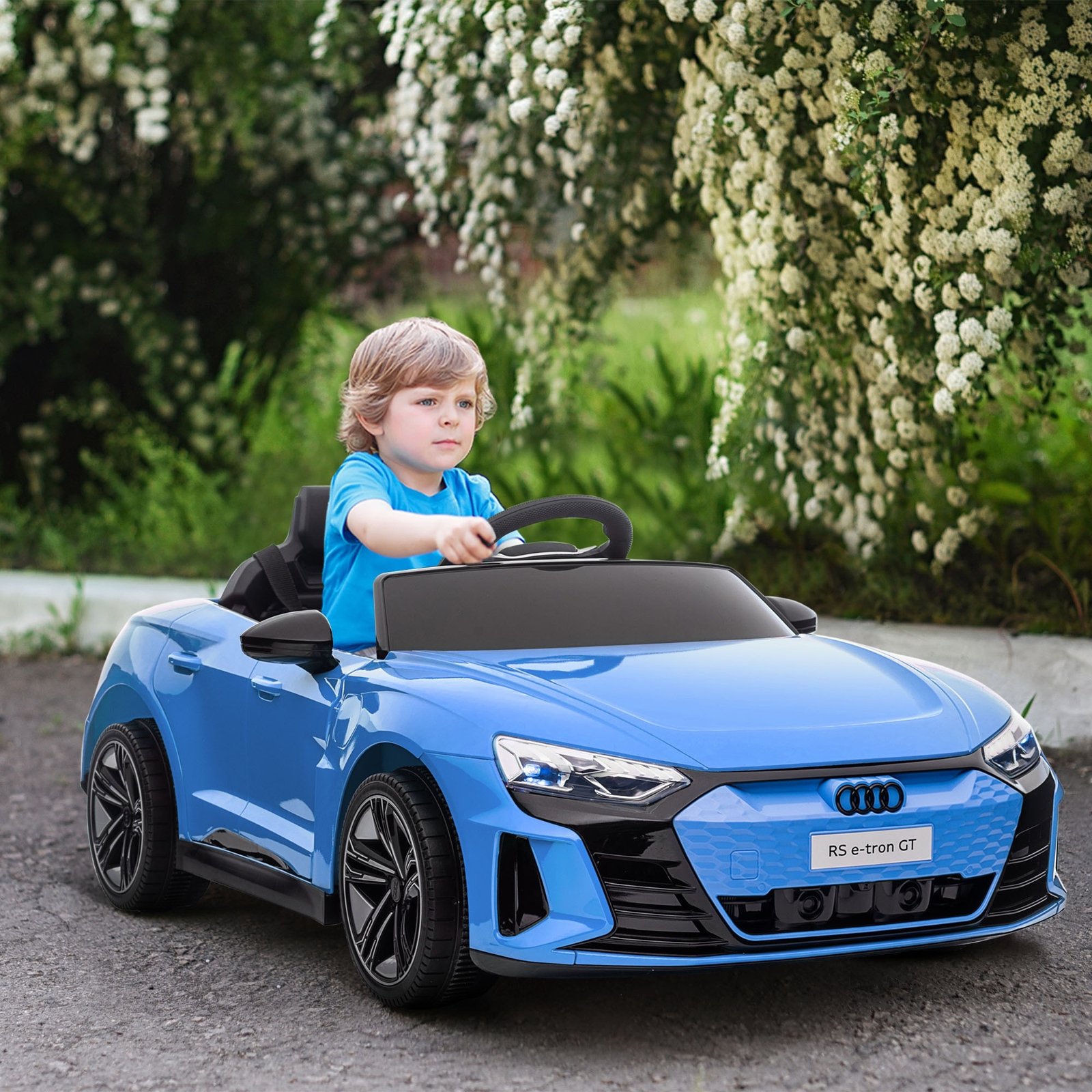 Child driving a blue electric ride-on car